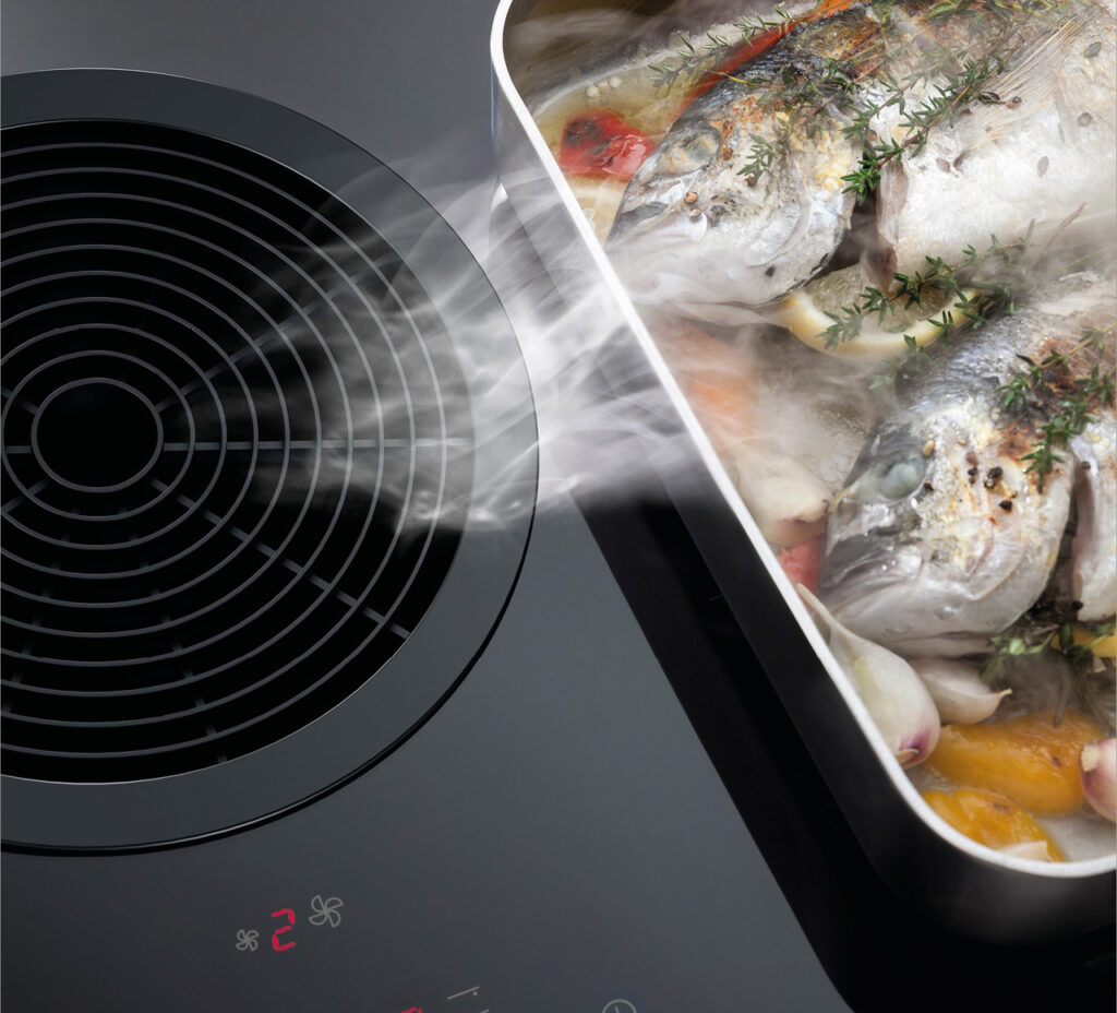 Integrierter Dunstabzug am Bora Kochfeld saugt Kochdampf neben Bräter ab